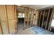 Interior view of a living room showcasing exposed wall studs during a remodeling project at 1099 Warren Dr, Riverdale, GA 30296