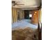 Partially renovated living room showing exposed framing, damage, and an older wooden front door at 1099 Warren Dr, Riverdale, GA 30296