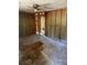Partially renovated living room featuring exposed framing, ceiling fan and a peek into the closet at 1099 Warren Dr, Riverdale, GA 30296