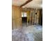 Partially renovated room showing the exposed framework and damaged hardwood floors at 1099 Warren Dr, Riverdale, GA 30296