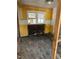 A partially renovated room, revealing the framework with yellow accent walls and natural light at 1099 Warren Dr, Riverdale, GA 30296