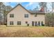 Spacious backyard featuring a two-story home with brick chimney and multiple windows at 1705 Butler Bridge Rd, Covington, GA 30016