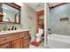 Bathroom showcasing a vanity with granite countertop, tiled shower, and separate bathtub at 1705 Butler Bridge Rd, Covington, GA 30016