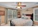 Cozy bedroom with large window, ceiling fan, and neutral color scheme at 1705 Butler Bridge Rd, Covington, GA 30016