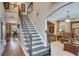 Spacious entryway showcasing a staircase with rod iron railing and hardwood floors flowing into the living spaces at 1705 Butler Bridge Rd, Covington, GA 30016