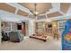 Spacious living room with coffered ceiling, multiple windows and leather recliner seating at 1705 Butler Bridge Rd, Covington, GA 30016