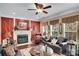 Elegant living room with a cozy fireplace, decorative mirrors, and large windows providing ample natural light at 1705 Butler Bridge Rd, Covington, GA 30016