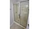 Bathroom with sliding glass shower doors, shower head, and built-in shelving at 2825 Northeast Expy # F 03, Atlanta, GA 30345