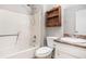 Cozy bathroom with a standard tub/shower combination, toilet, sink, and storage shelf at 495 Buttercup Trl, Lawrenceville, GA 30046