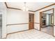 Open dining room with tile flooring, a chandelier, and an open doorway to the living room at 495 Buttercup Trl, Lawrenceville, GA 30046