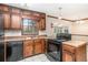 A kitchen area shows cabinets, counter tops, an oven, and a dishwasher at 495 Buttercup Trl, Lawrenceville, GA 30046