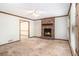 A living room features a brick fireplace, a ceiling fan, and neutral walls at 495 Buttercup Trl, Lawrenceville, GA 30046