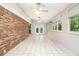 Sun room with lots of natural light, tile flooring and brick accents at 495 Buttercup Trl, Lawrenceville, GA 30046