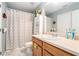Bathroom with sink, cabinets, mirror, and shower with striped curtain at 1850 Brooks Pointe Ct, Lawrenceville, GA 30045