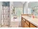 Charming bathroom featuring an alcove tub with a shower curtain and floral accents on the walls at 1850 Brooks Pointe Ct, Lawrenceville, GA 30045