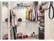 Walk-in closet with shelving, hanging rods, and a variety of clothing and accessories neatly organized at 1850 Brooks Pointe Ct, Lawrenceville, GA 30045
