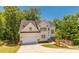 Charming two-story home with landscaped yard, inviting walkway, and attached two-car garage at 1850 Brooks Pointe Ct, Lawrenceville, GA 30045