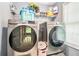 Bright laundry room equipped with modern appliances, storage shelves, and plenty of natural light at 1850 Brooks Pointe Ct, Lawrenceville, GA 30045