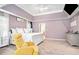 Bright bedroom with a white bed, accent chair, carpet and tray ceiling, creating a comfortable retreat at 1850 Brooks Pointe Ct, Lawrenceville, GA 30045