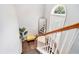 Hallway staircase features a mirror and natural light from the arched window at 1850 Brooks Pointe Ct, Lawrenceville, GA 30045