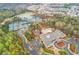 Overhead view of community amenities featuring a pool, tennis courts, lake, and clubhouse in a residential area at 201 Aster Ct, Canton, GA 30114