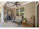 Outdoor covered porch featuring furniture and wooded backyard views at 201 Aster Ct, Canton, GA 30114
