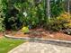 Backyard featuring a manicured mulch bed with plants and mature trees at 201 Aster Ct, Canton, GA 30114