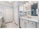 Bright bathroom with modern vanity, ample storage, and a large framed mirror at 201 Aster Ct, Canton, GA 30114