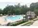 Relaxing community pool area with lounge chairs, shade structures, and lush greenery at 201 Aster Ct, Canton, GA 30114