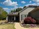 Beautiful home featuring blooming flowerbeds, mature landscaping, and inviting front porch with seating at 201 Aster Ct, Canton, GA 30114