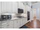 Modern kitchen featuring stainless steel appliances, granite countertops, and white cabinets at 201 Aster Ct, Canton, GA 30114