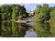 Scenic lake view featuring an outdoor performance space and a beautiful house in the background at 201 Aster Ct, Canton, GA 30114