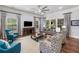 Bright living room featuring a ceiling fan, patterned curtains, and comfortable seating at 201 Aster Ct, Canton, GA 30114
