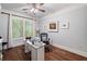 Well-lit office space features a hardwood floor, a ceiling fan, and a window with natural light at 201 Aster Ct, Canton, GA 30114