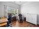 Well-lit office space features hardwood floors, an ergonomic chair, a massage chair, and a large window at 201 Aster Ct, Canton, GA 30114