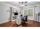 Well-lit office space features a hardwood floor, a ceiling fan, built in shelving, and a window with natural light at 201 Aster Ct, Canton, GA 30114