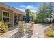 View of the brick patio area with a table and chair set and an umbrella for shade at 201 Aster Ct, Canton, GA 30114