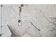 Close up of a marble tiled shower with a handheld shower head and a bench at 201 Aster Ct, Canton, GA 30114