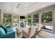 Bright sunroom featuring large windows with views of the lovely, landscaped outdoor scenery and comfortable seating at 201 Aster Ct, Canton, GA 30114