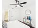 Bright bedroom with dark floors, ceiling fan, and ensuite bathroom with glass shower at 2201 Huntingdon Chase St, Atlanta, GA 30350
