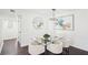 Bright dining room with a modern chandelier, glass table, seating for four, and hardwood floors at 2201 Huntingdon Chase St, Atlanta, GA 30350