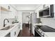 Updated kitchen featuring white cabinets, stone countertops, stainless appliances, and an eat-in nook at 2201 Huntingdon Chase St, Atlanta, GA 30350