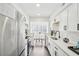 Modern kitchen with white cabinets, stainless steel appliances, and dining nook with natural light at 2201 Huntingdon Chase St, Atlanta, GA 30350