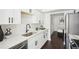 Well-lit kitchen with white cabinets, quartz countertops, modern hardware, and stainless steel appliances at 2201 Huntingdon Chase St, Atlanta, GA 30350