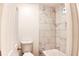 Bathroom with marble tile shower and white toilet at 2745 Saxon Drive, Duluth, GA 30096