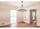 Bright dining room featuring wood floors, new lighting, and natural light from large window at 2745 Saxon Drive, Duluth, GA 30096