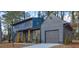 Two-story home with a gray exterior, well-maintained landscaping, and an attached garage at 4210 Pepperdine Dr, Decatur, GA 30034