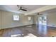 Bright living room boasts hardwood flooring, fan, and sliding glass doors to the deck at 4210 Pepperdine Dr, Decatur, GA 30034
