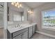 Bathroom featuring double sinks, tile floors, and community views at 1179 Bennett Creek Overlook, Suwanee, GA 30024