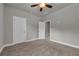 Neutral bedroom with carpet, ceiling fan, and white doors at 1179 Bennett Creek Overlook, Suwanee, GA 30024